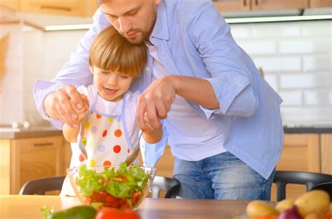 Premium Photo | Dad and child making a salad