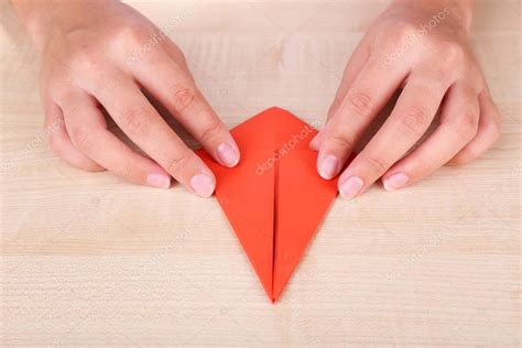 Hands making origami figure, close up — Stock Photo © belchonock #49496317