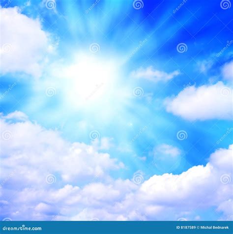 Sunny Blue Sky With Fluffy Clouds. Sunlight With Rays Illuminates The