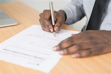 Person Signing in Documentation Paper · Free Stock Photo