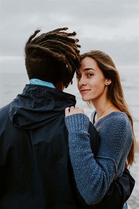 Download Interracial Couple Posing Outside Girl Looking Wallpaper