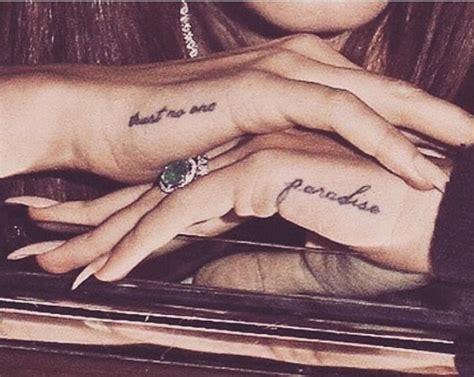 Lana Del Rey’s hand tattoos “trust no one” and “paradise” plus the ...