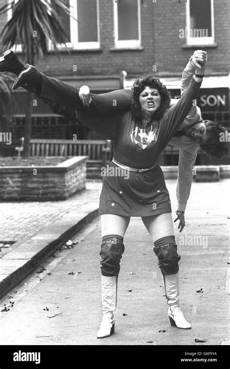 Female wrestler Deanna Booher holds aloft PA reporter Peter Archer ...