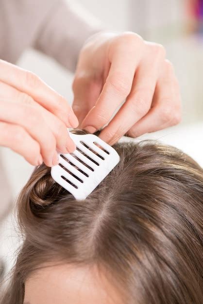 premium photo hairdresser putting hair clips   woman hair close
