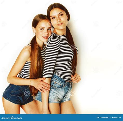 Two Cute Teenagers Having Fun Together Isolated on White Stock Photo