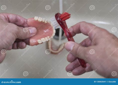 Denture Cleaning With Brush Stock Photo | CartoonDealer.com #130063641