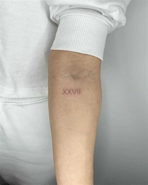 Roman numerals XXVII tattoo by Conz Thomas inked on the left forearm | Tattoos, Fine line ...