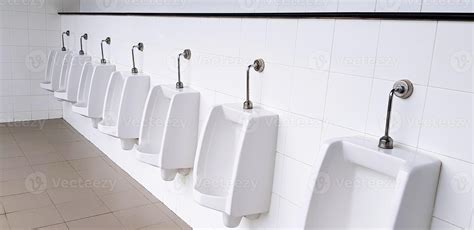 White urinal on white wall in men public toilet, washroom or rest room