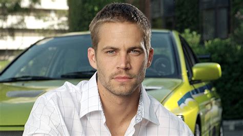 Download Paul Walker Posing Front Of Car Wallpaper | Wallpapers.com
