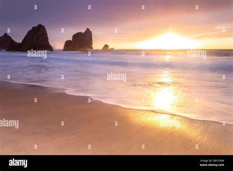 Sunset on the beach of Praia da Ursa,with the giant Ursa and Gigante ...