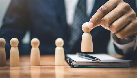 Wooden figure representing a manager hiring new recruits symbolizing ...