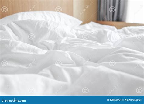 Messy white bed sheets stock image. Image of duvet, rippled - 128732731