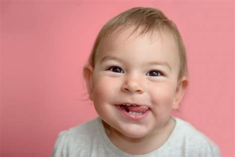 Premium Photo | Cute happy funny baby toddler face smiling showing ...