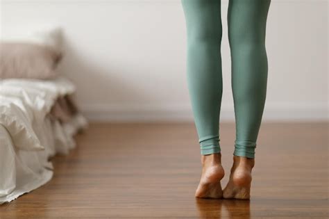 Premium Photo | Young woman in sports leggings walks barefoot on the ...