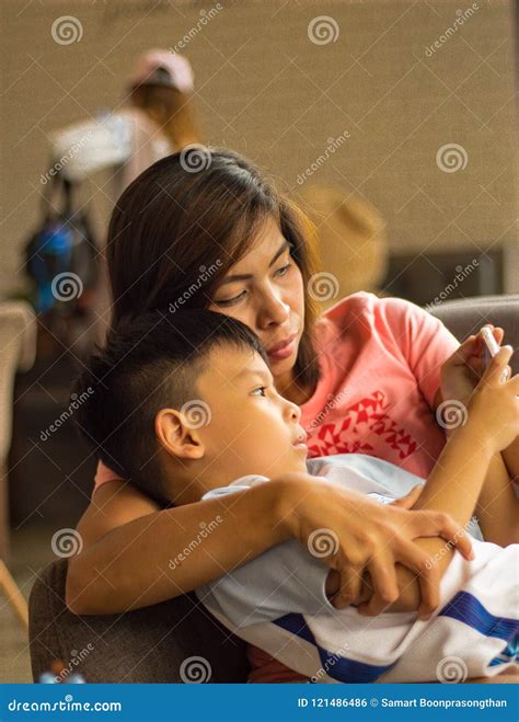 Mother and Son Watching the Phone Happily. Stock Photo - Image of movie