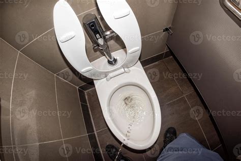 Man urinating in public restroom 20425057 Stock Photo at Vecteezy