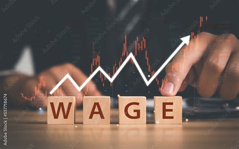 businessman pointing finger  word wage  wooden block wage concept