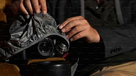 A man is secretly filming a video while watching a movie at the cinema