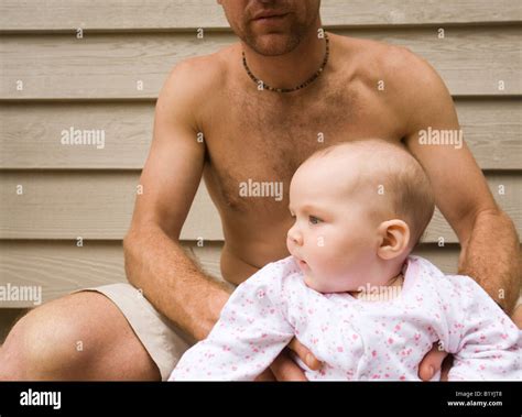 bare chested father holding baby daughter stock photo alamy