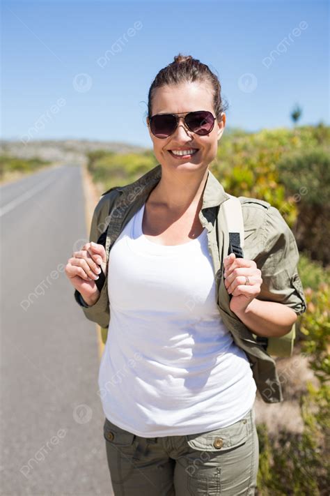 Beautiful Woman Hitchhiking On The Road With Her Thumb Out Photo