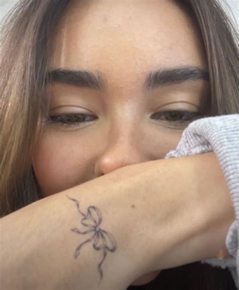 Madison Beer's Delicate Bow Tattoo