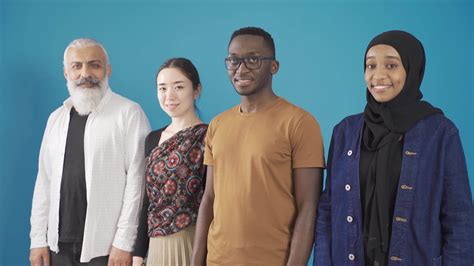 European man, Asian woman and African man and woman looking at camera