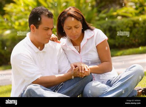 Couple praying together Stock Photo - Alamy