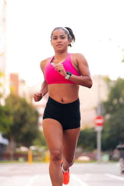 Premium Photo | Female athlete running during her training at city