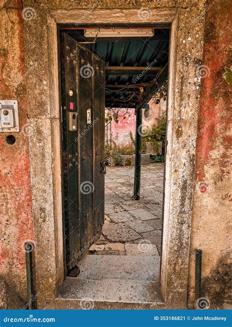 Ancient Doorway Leads into an Antique Tiled Courtyard in a Villa