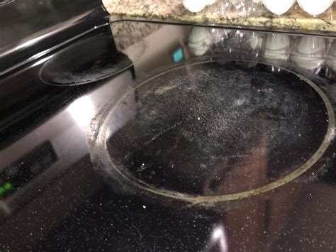 How to clean electric glass top stove? Idk what’s stuck to it, there’s a hard water ring maybe ...