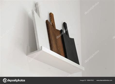 Shelf with different wooden boards Stock Photo by ©belchonock 169647622