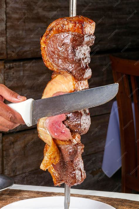 Premium Photo | Steak rotisserie at the steakhouse sliced picanha Picanha