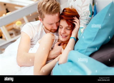 Couple bedroom love romance kiss intimacy bed hi-res stock photography