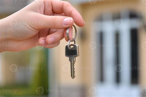 AI generated Hand hold keys in front of new home. Concept of buying