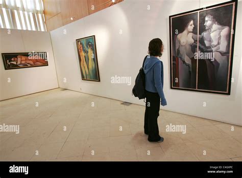 Person looking at paintings in art gallery Stock Photo - Alamy