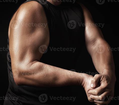 adult man with a sports figure in black clothes strained his muscles in