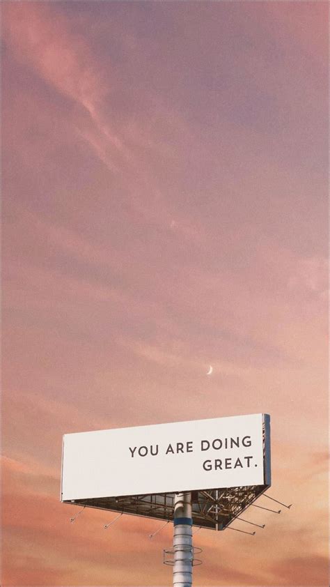 a billboard with the words you are doing great on it in front of a pink sky