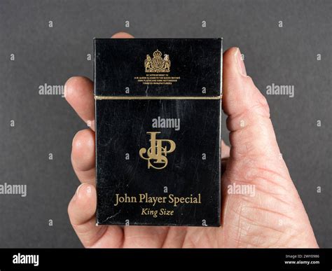 man holding  original empty packet   john player special jps