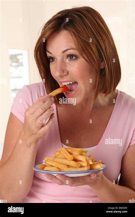 WOMAN EATING FRENCH FRIES Stock Photo - Alamy