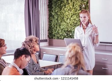 active discussion cheerful girl holding laptop stock photo