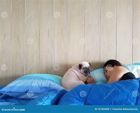 Young Woman Owner is Lying and Sleeping with Pug Dog in Bed Stock Photo - Image of cuddle ...