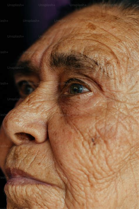 A close up of a woman's face with wrinkles photo – Oily skin Image on