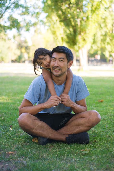 Free Photo | Portrait of happy man and little girl on grassy field in