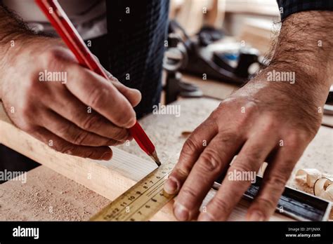 Carpenter makes pencil marks on a wood plank Stock Photo - Alamy