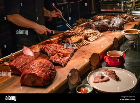 chef  meat buffet counter cutting delicious grilled ribs stock photo