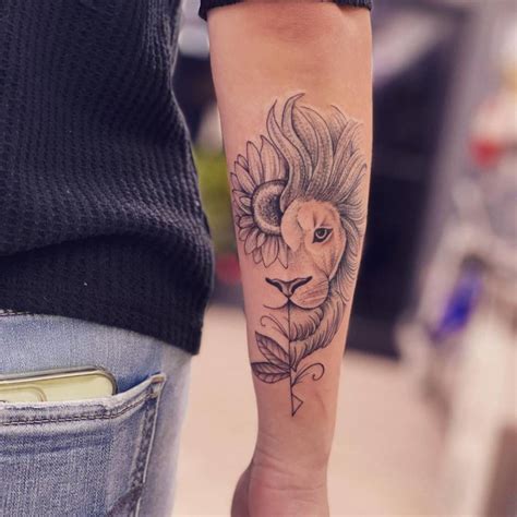 Half lion, half sunflower tattoo on the forearm