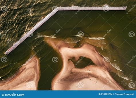 Breakwater on the beach stock photo. Image of water - 293925764