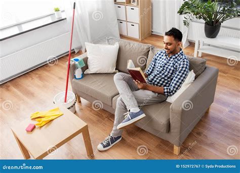 Man Reading Book and Resting after Home Cleaning Stock Image - Image of ...
