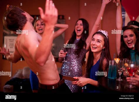 Young women watching male stripper at hen party Stock Photo - Alamy