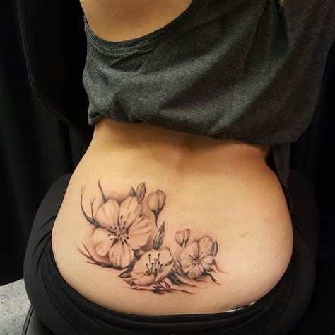 Chronic Ink Tattoo - Toronto Tattoo Lower back flower cover up tattoo ...